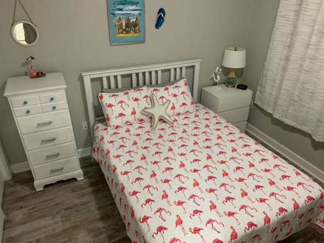 Guest bedroom includes queen bed with attached bathroom and large closet.