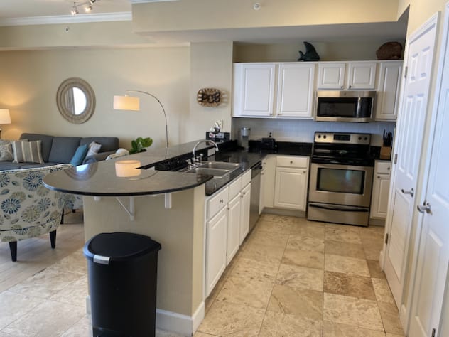 Full size kitchen with granite countertops and stainless appliances