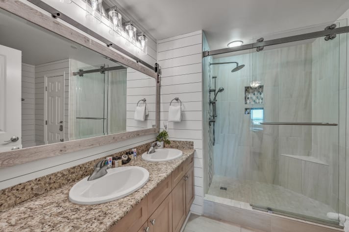 Large master bathroom with dual vanity, spacious walk in shower.
