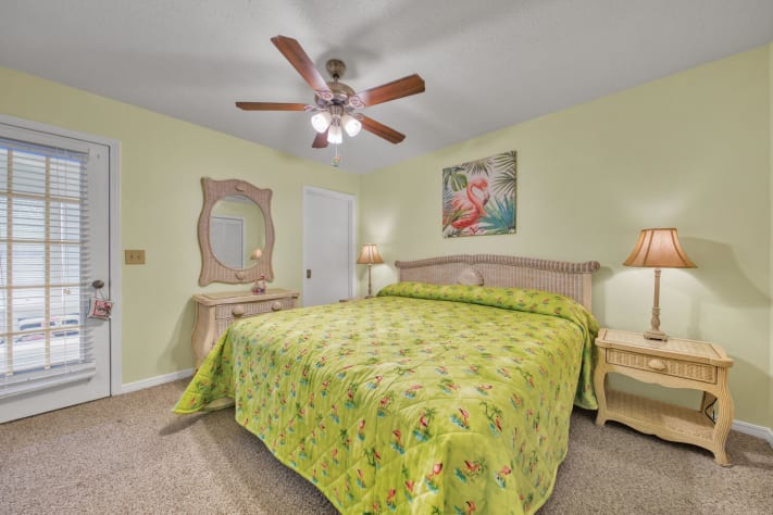 King size bed w/spacious closet and view of the Pink Flamingo Sun Porch