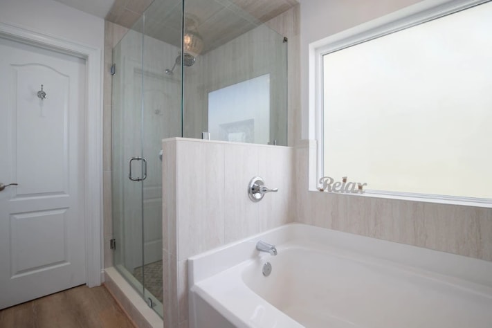 Master shower with rain head and separate soaker tub. 