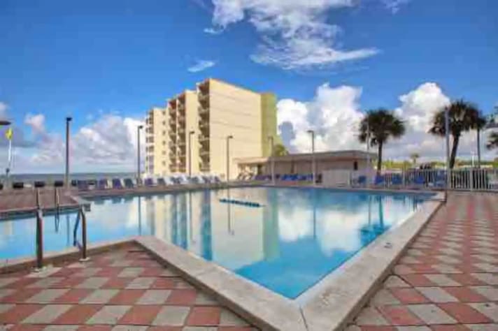 Heated swimming pool with ocean view and couple steps to the beach 