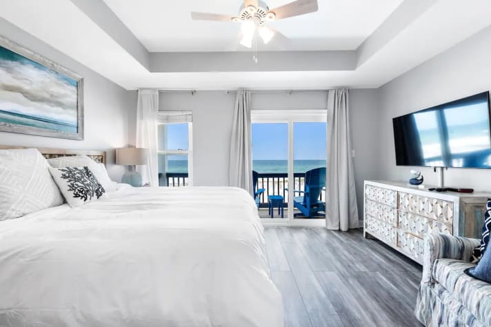 Bedroom with TV and open access to the patio