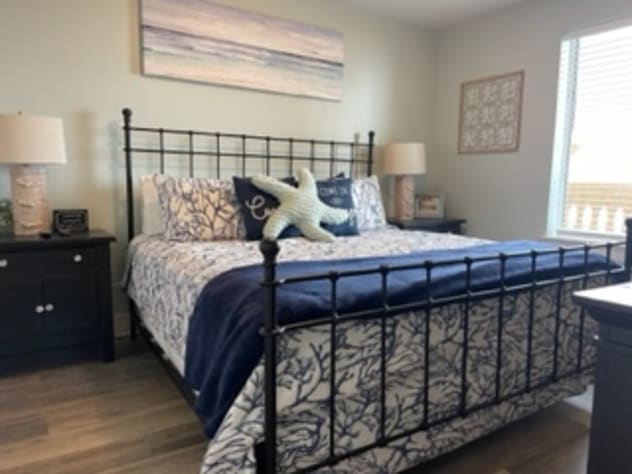 Guest bedroom has a king bed and 55" tv and is attached to private bath