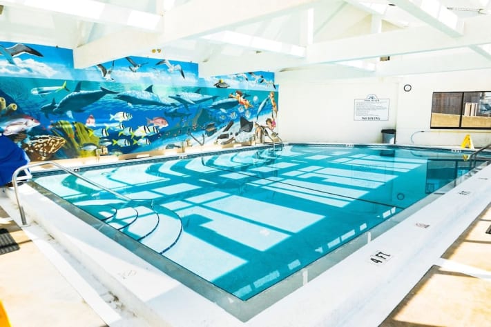 Glass enclosed heated pool with ocean view.