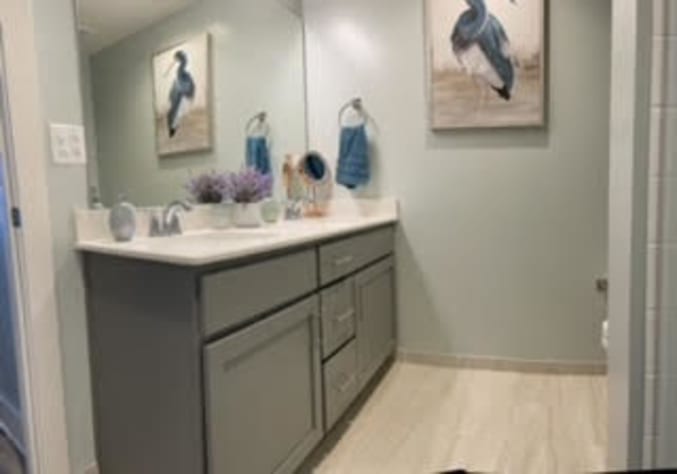 Master bathroom has walk in shower and a teek bench
