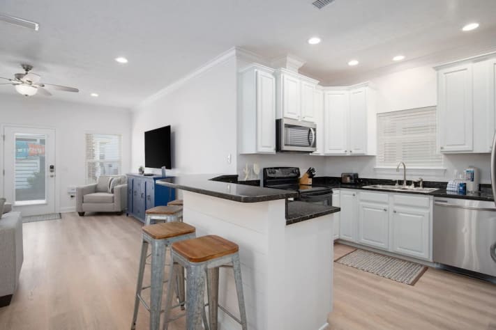 Fully equipped kitchen with granite counters and new French door fridge. 