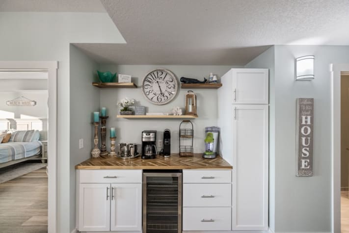 Coffee bar area has regular coffee pot and Keurig and wine/pop fridge.