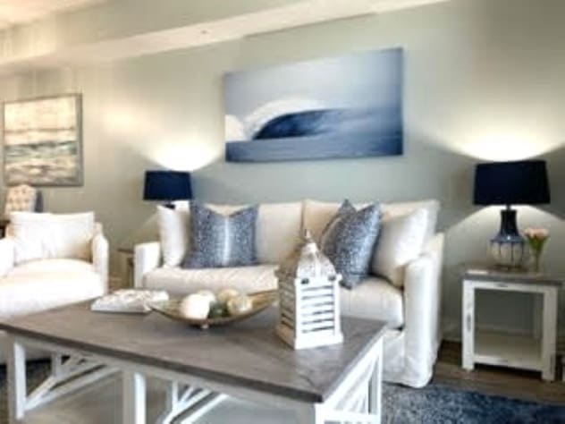Gorgeous living room with 83" tv and sleeper sofa.