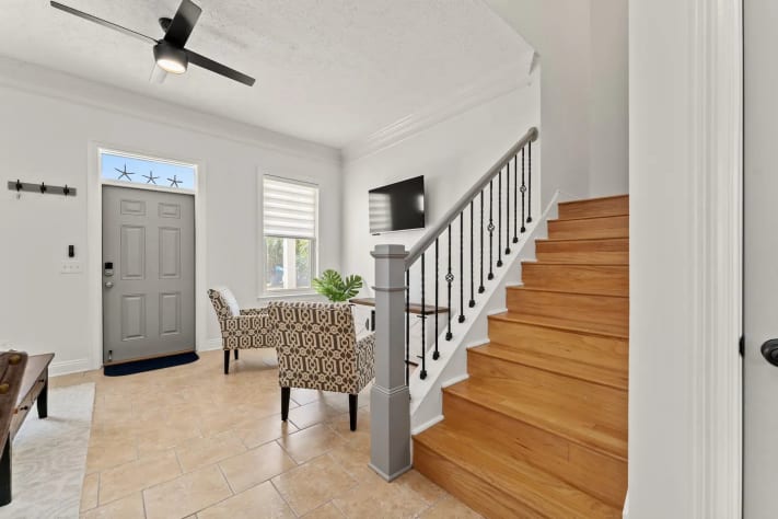Entry Way, Sitting Area with Fireplace, and Stairway