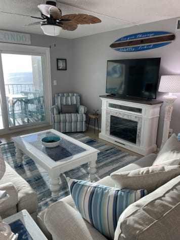 Watch your favorite show on this large TV by the fireplace.