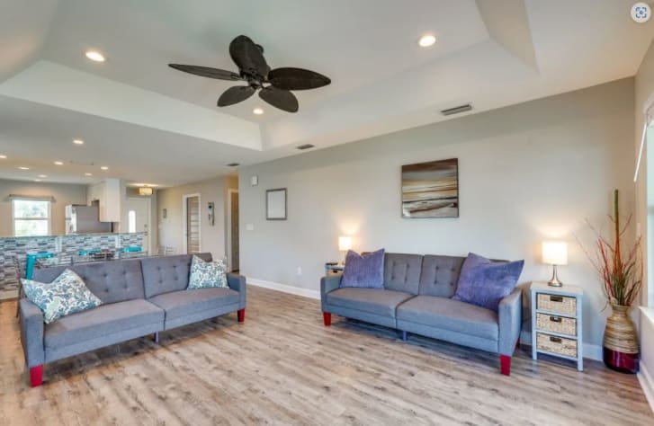 The great room features 2 arcade machines, 2 futons, and a smart TV
