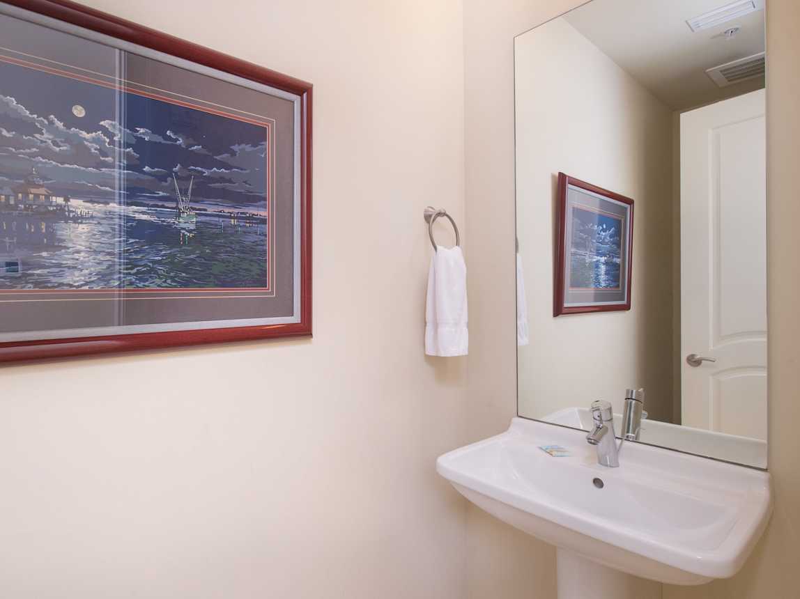 Convenient half bath located between the living area and hall bedrooms