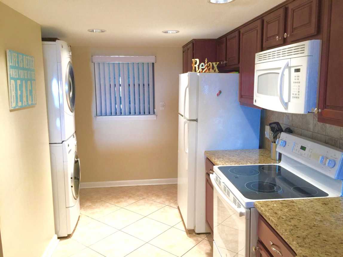Full Size LG Stack Washer and Dryer. Lots of Custom Storage Cabinets.
