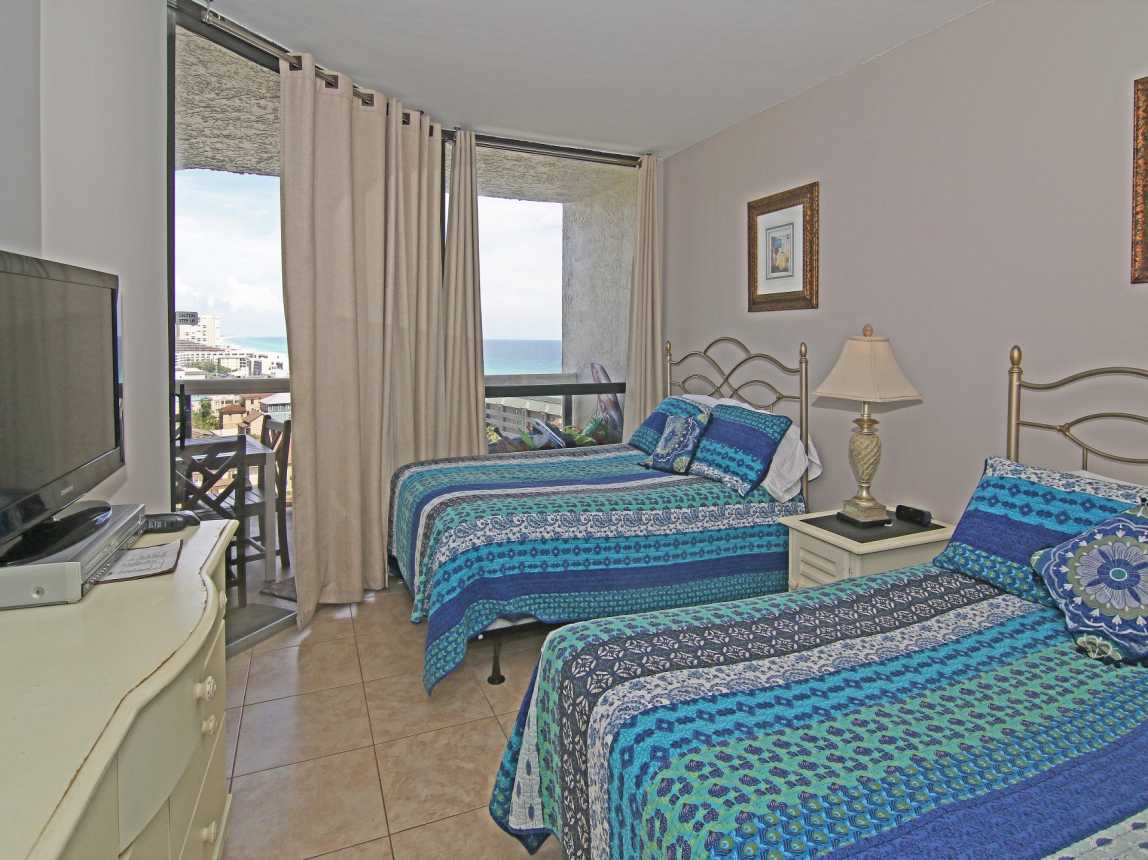 2nd bedroom has 2 queen beds, balcony access, flat screen TV, ceiling fan