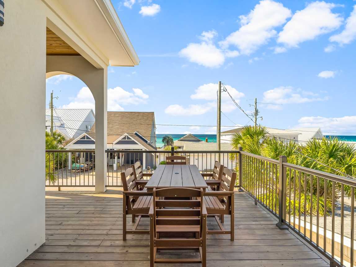 2nd floor patio with dining area and gorgeous beach view