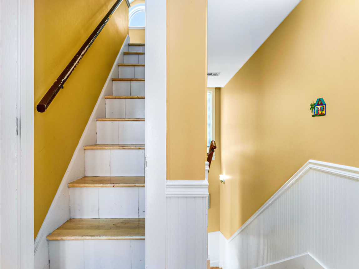 Stairs to loft going up and stairs going down leading to bedrooms