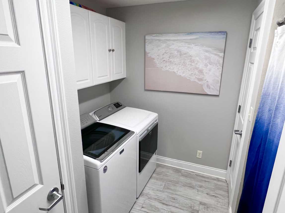 Laundry room with FULL SIZE WASHER AND DRYER for clean beach towels daily!