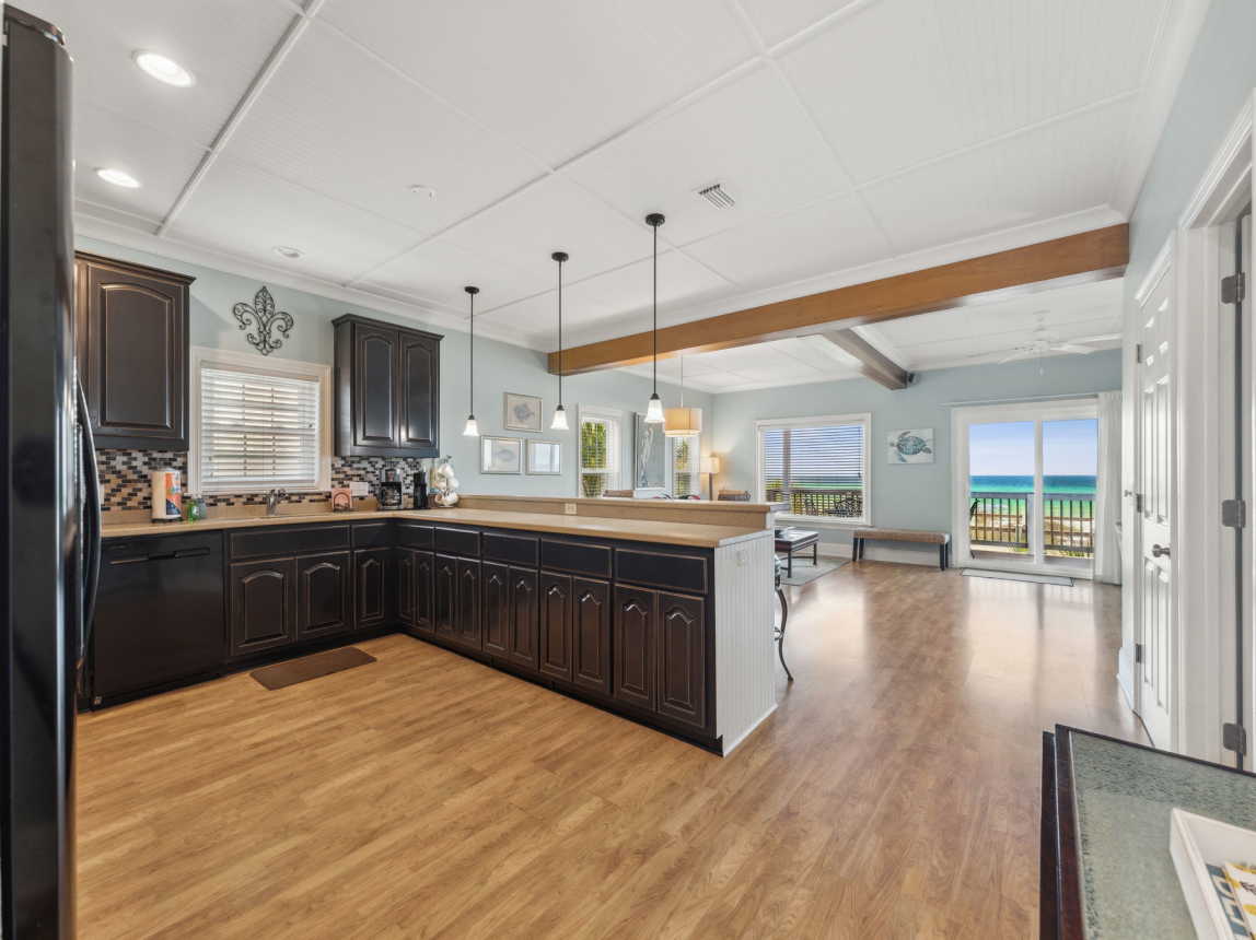 Open kitchen, living and dining room with sliding doors to the beach