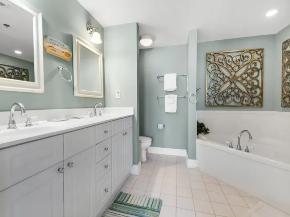 Master bath with double vanities, soaking tub, and separate oversized shower