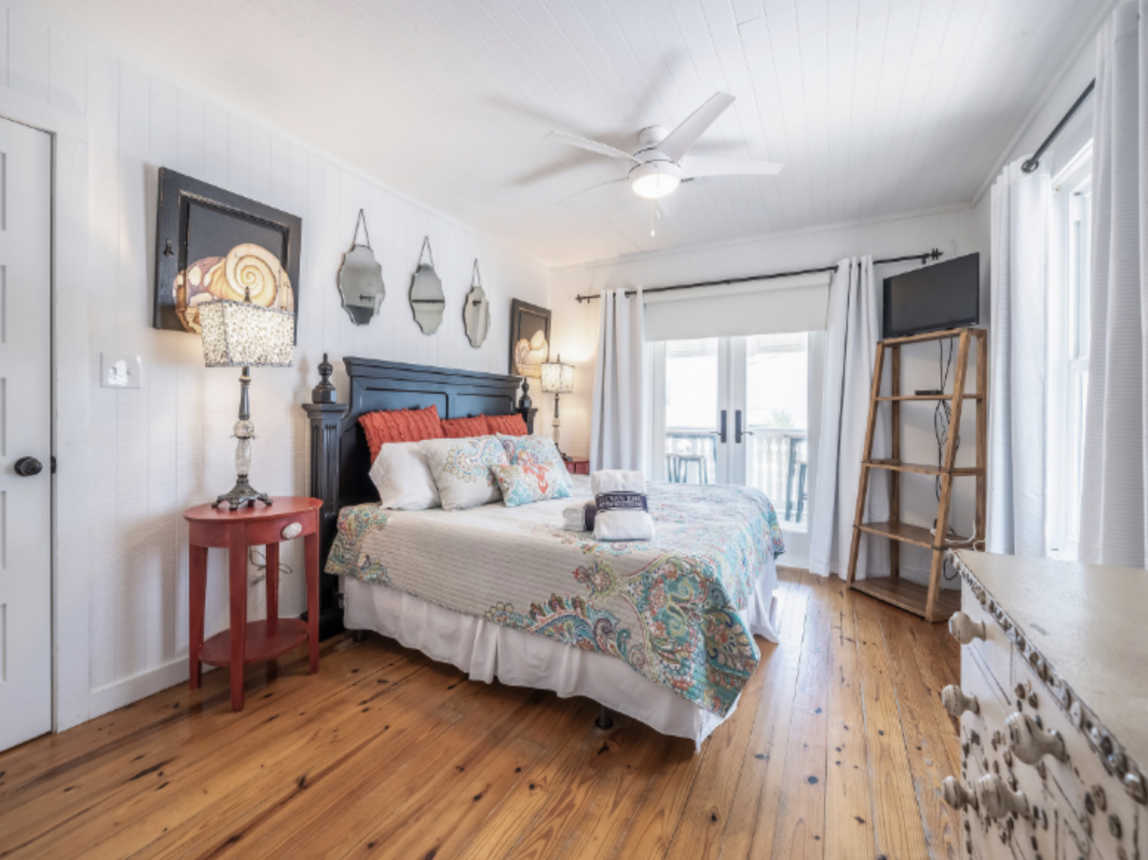 Primary bedroom with ocean view. King bed. Opens to the porch