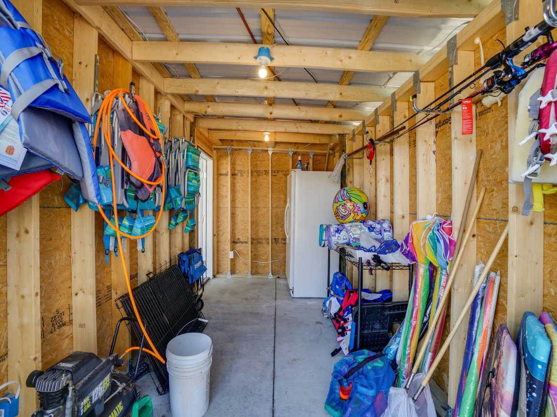 Our beach gear storage. Air compressor, kennels, rods, toys, games, nets, boards