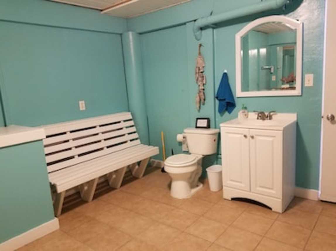 Carport/pool bathroom with extra full size fridge/freezer.  Outdoor shower also.