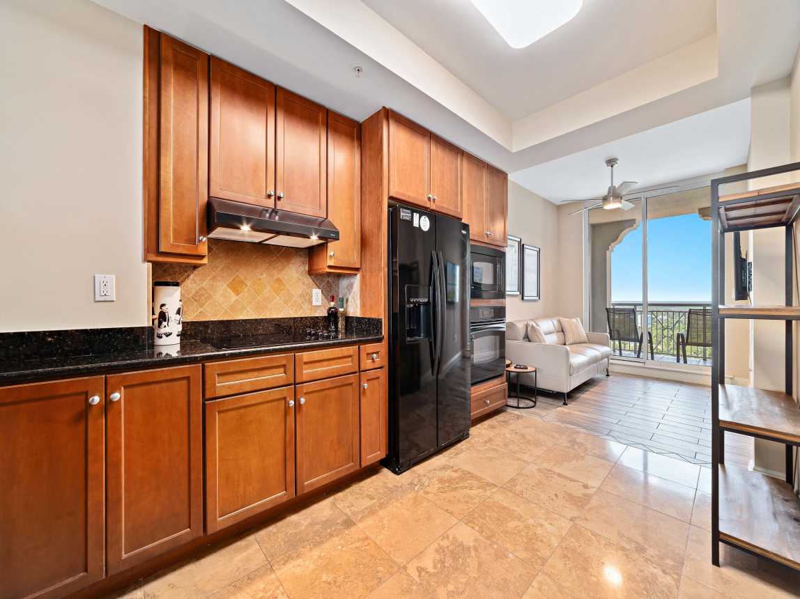 View through the kitchen and into the media room, and "second" balcony 