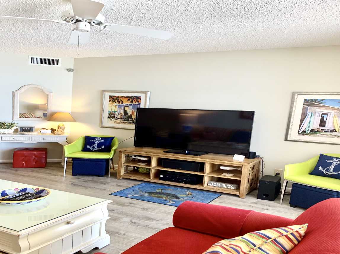 Gulf Front living room with 60in TV and 5.1 surround sound system balcony access