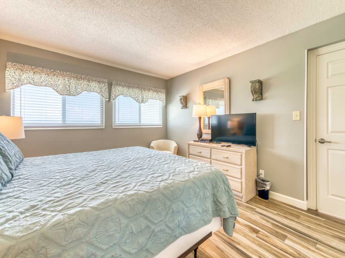 Unwind in this cozy king bedroom with a TV for your entertainment.