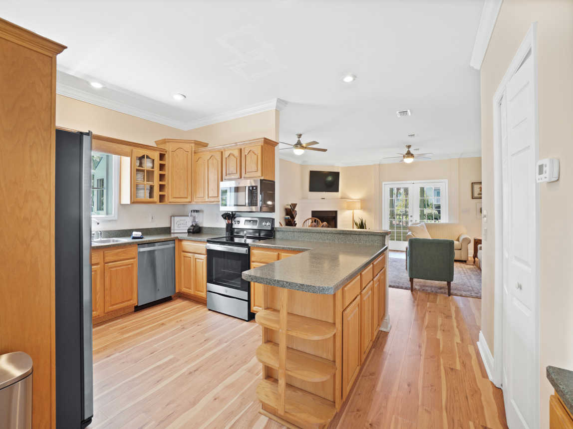 View from entryway into open kitchen, living, and dining on main floor.