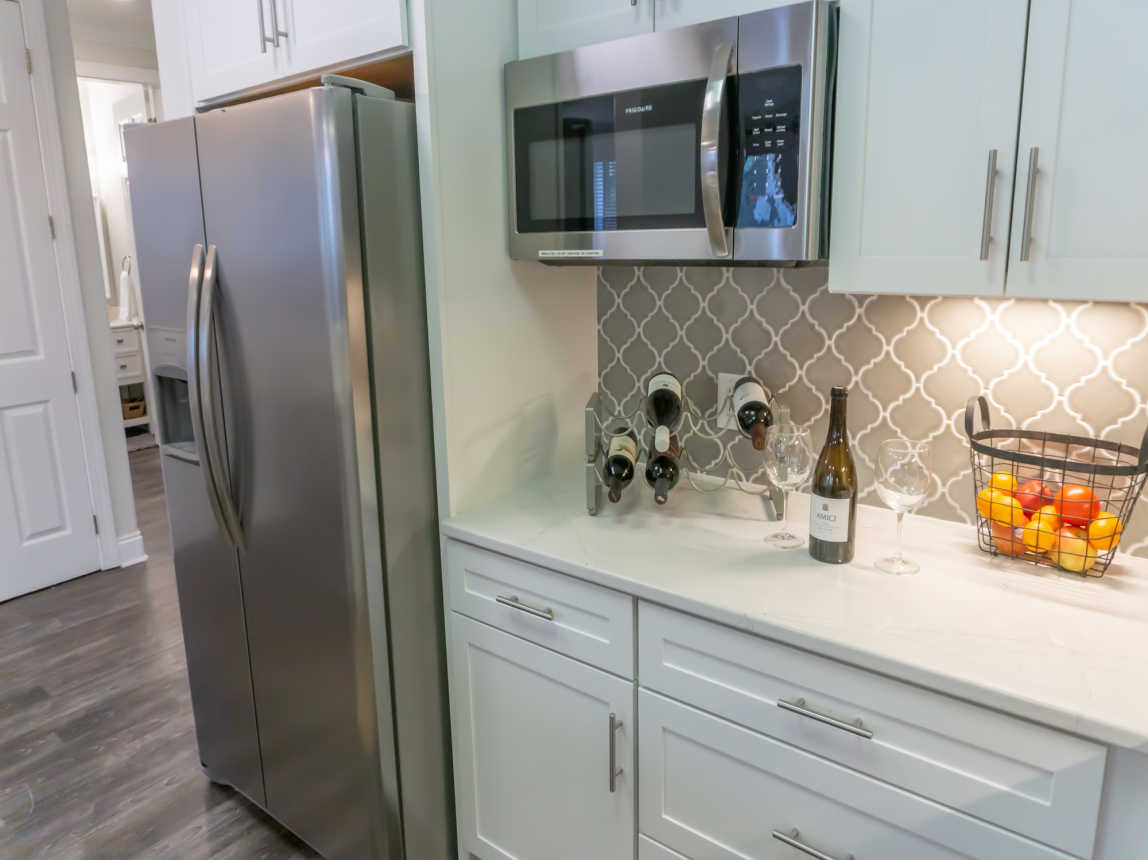 enjoy a drink in the brand new kitchen with custom cabinetry