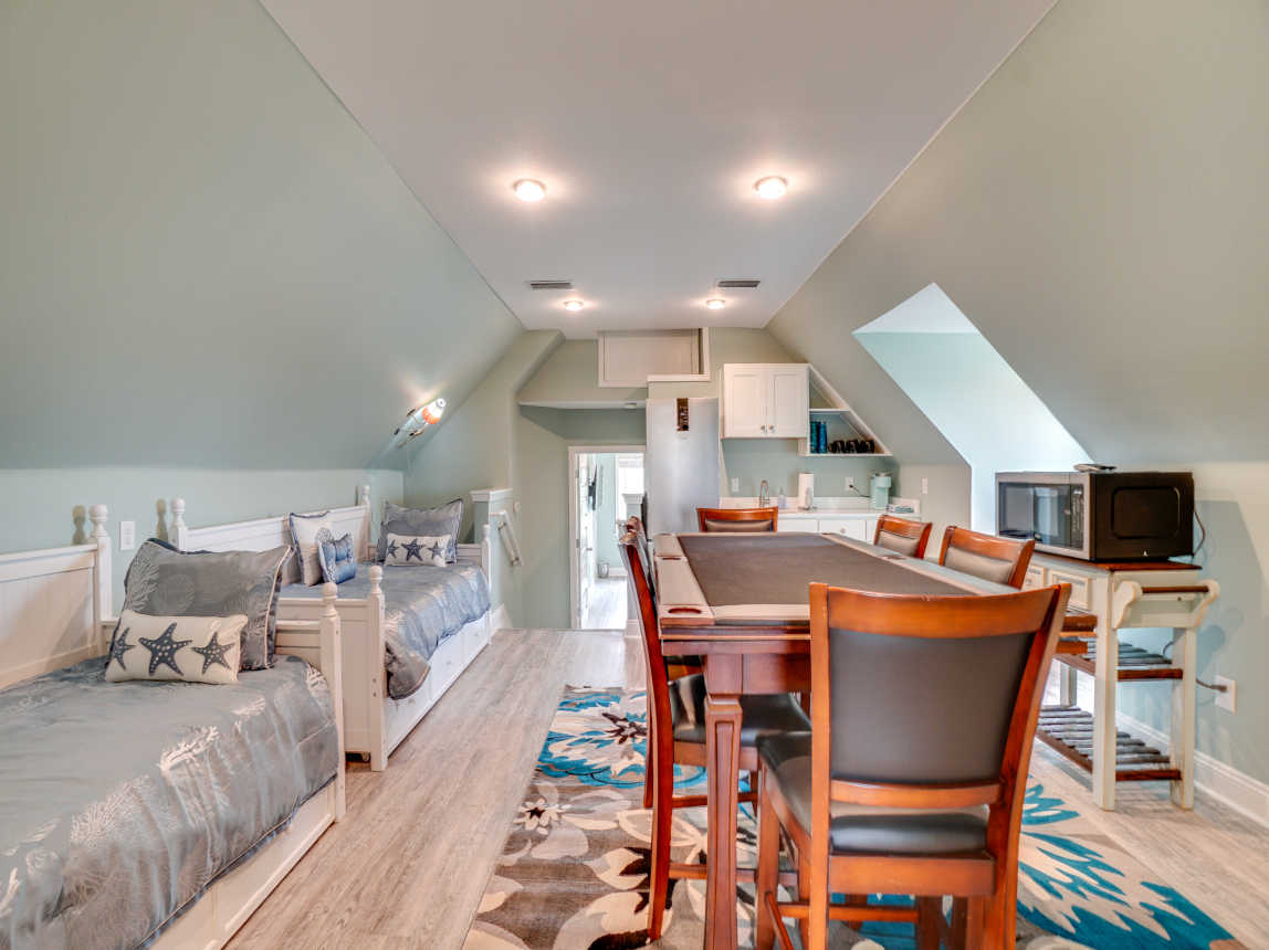 Gaming table, day beds and Kitchenette on second floor.