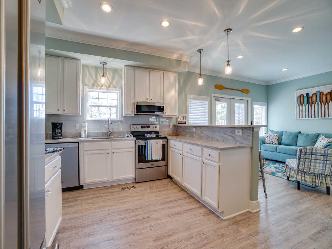 Kitchen with new solid counter tops and all new appliances. Bar seating for 4.