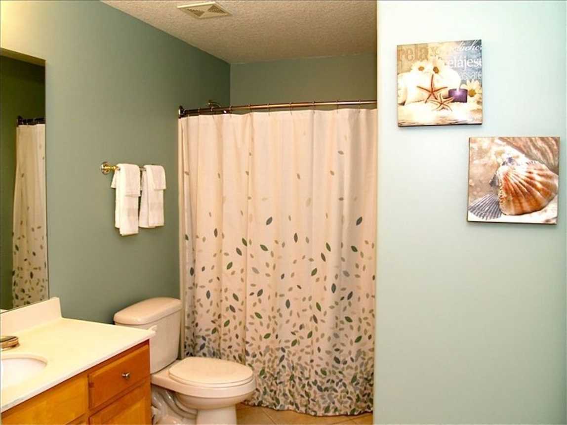 Both bathrooms are roomy and offer curved hotel shower rods.