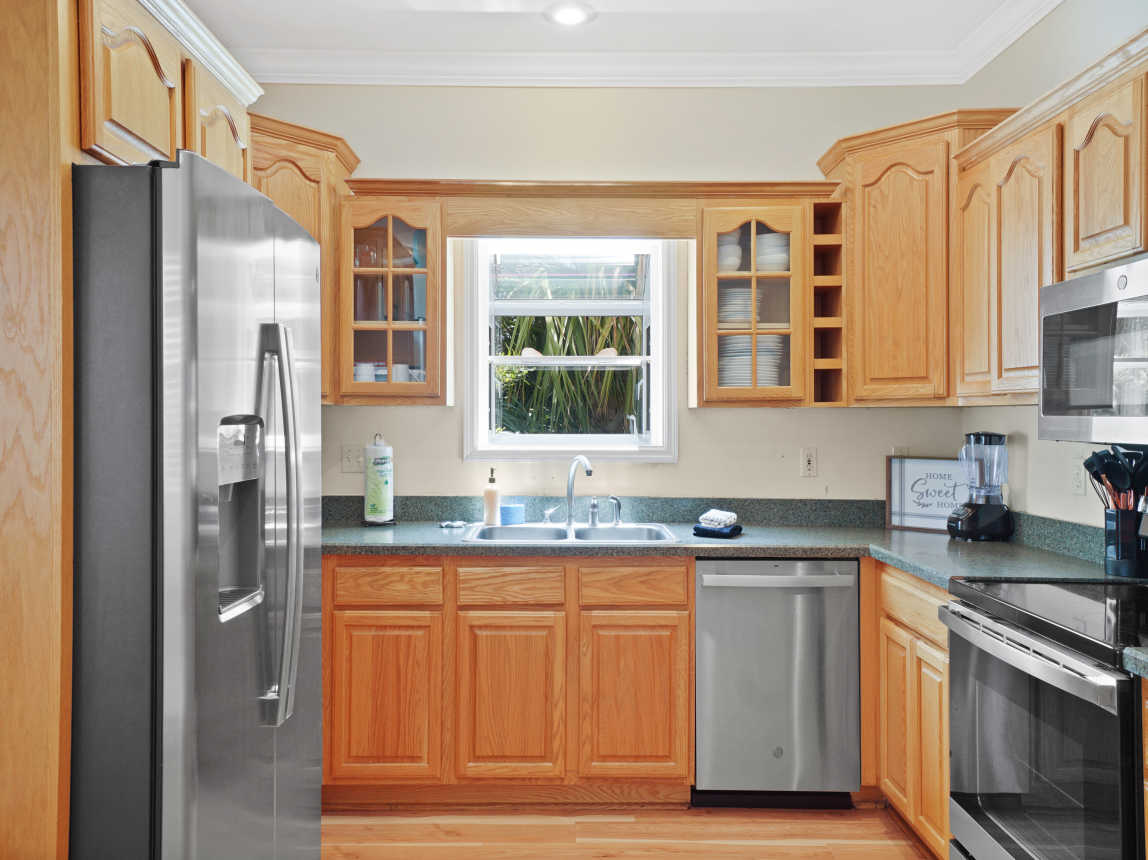 Kitchen with new stainless steel appliances.