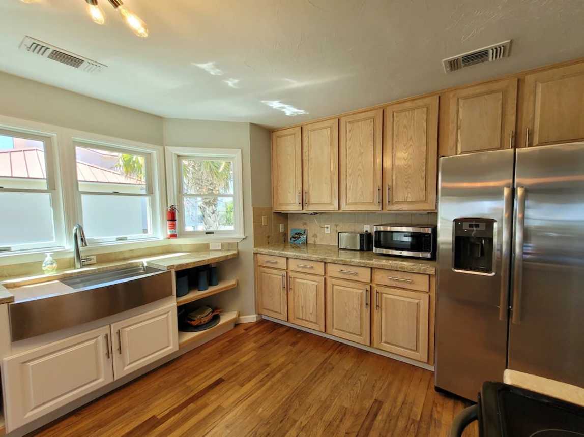 Side by side full size refrigerator/freezer with water and ice dispenser. 