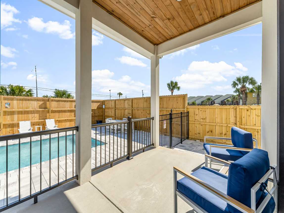 Back patio, pool is fenced off for safety and there is a side yard 