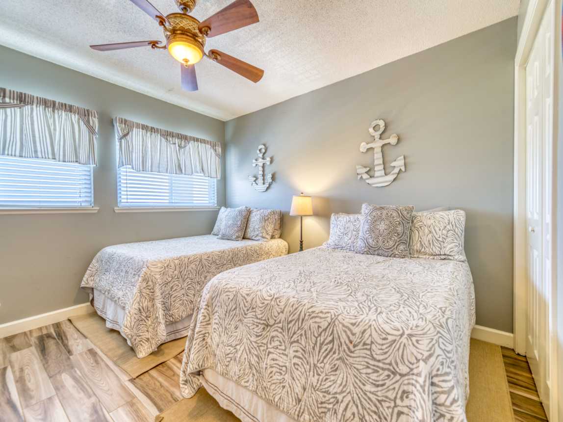 A cozy guest bedroom with two full beds.