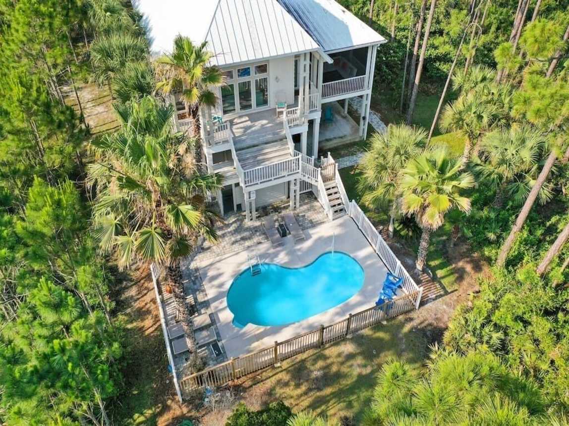 Bayside view of the main house, pool, heated outdoor shower. Pool has gorgeous views of the bay.