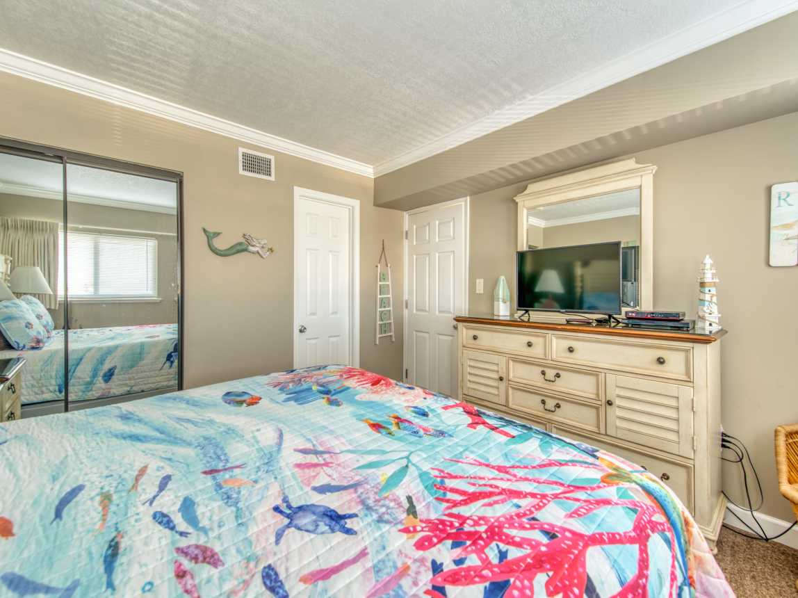 Unwind in this cozy king bedroom with a TV for your entertainment.