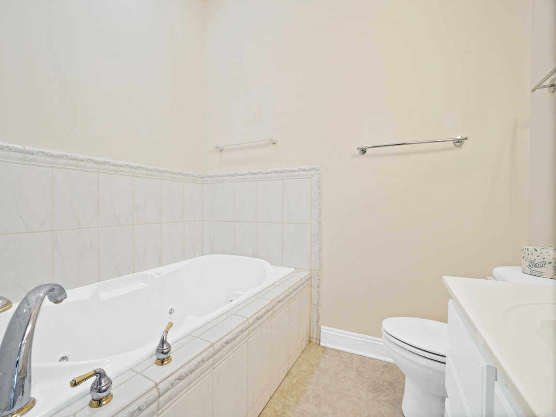 Upstairs hall bathroom with jacuzzi tub and handheld shower head.
