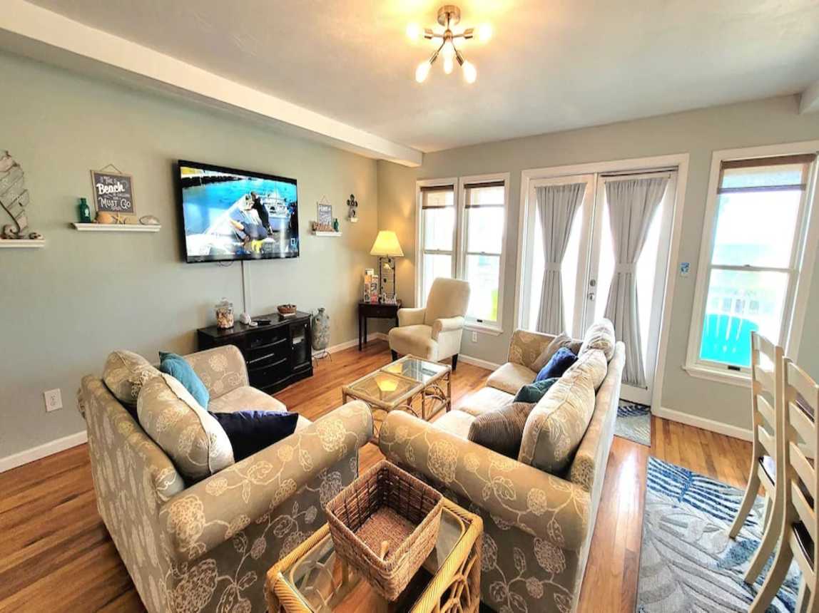 Living room with seating for 6 and large screen smart TV and DVD player