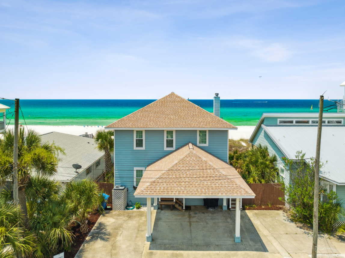 Drone of the front side of the house and beach on Front Beach Road