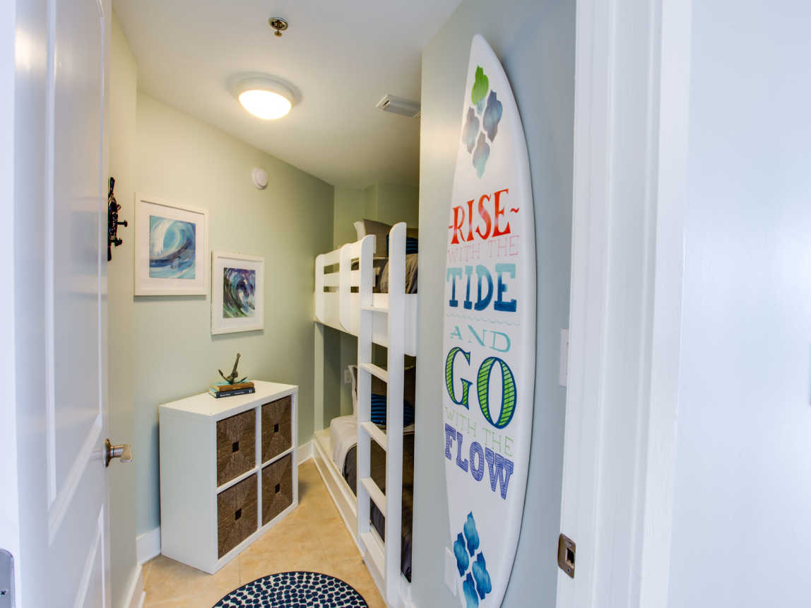 The kiddos are sure to love our surf themed bunkroom with PRIVACY DOOR and nearby half-bathroom