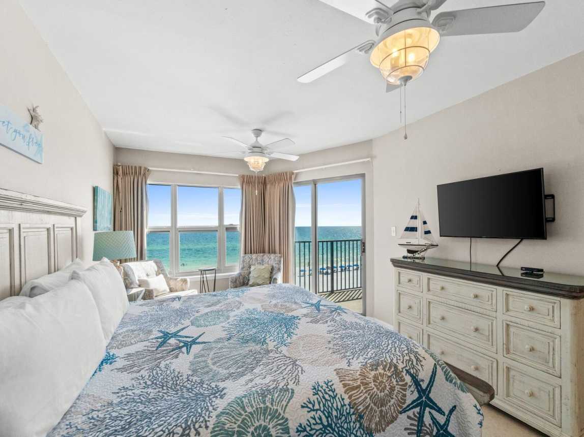 Master suite features a king-size bed, access to the balcony, and a private bathroom with a shower/tub combo.