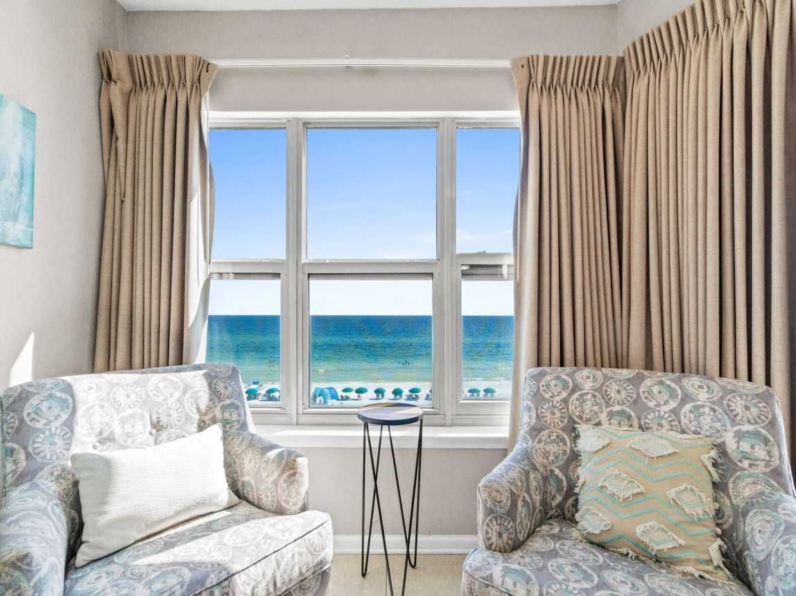 Master suite features a king-size bed, access to the balcony, and a private bathroom with a shower/tub combo.