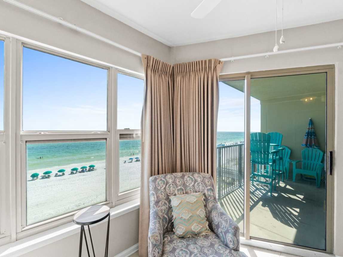 Master suite features a king-size bed, access to the balcony, and a private bathroom with a shower/tub combo.