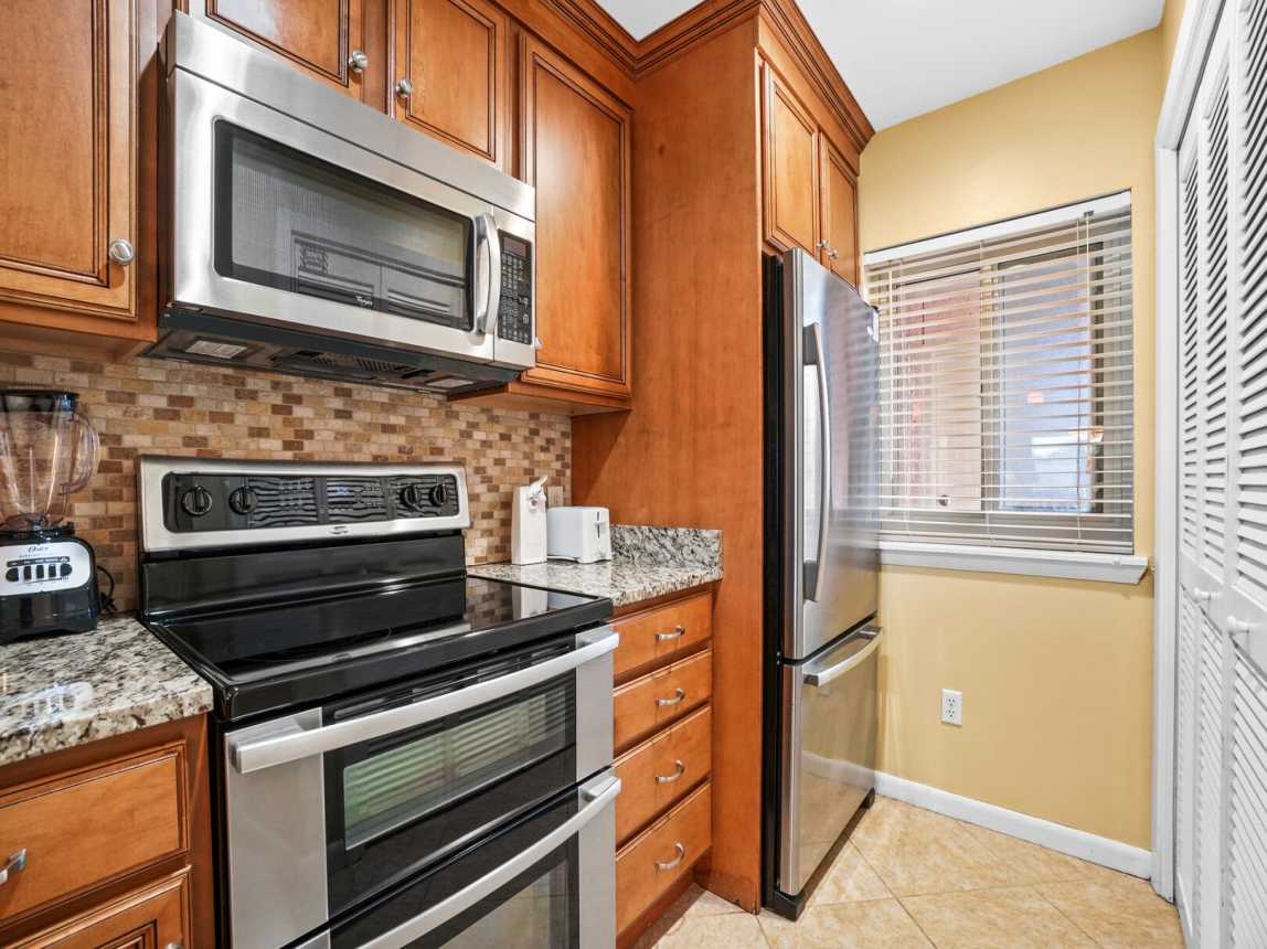 Kitchen with large refrigerator/freezer and behind doors you will find full size washer and dryer. So convenient!