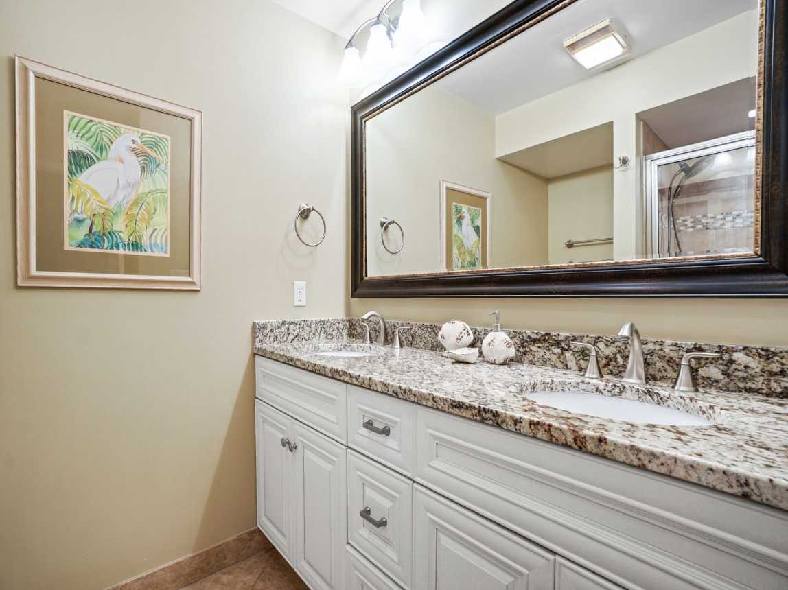Master bath has a spacious 2 sink vanity with full horizontal mirror and plenty of drawer and cabinet space.